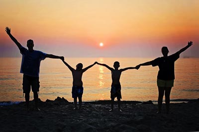 family holding hands sunset